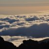 Clouds above mountains at sunset.